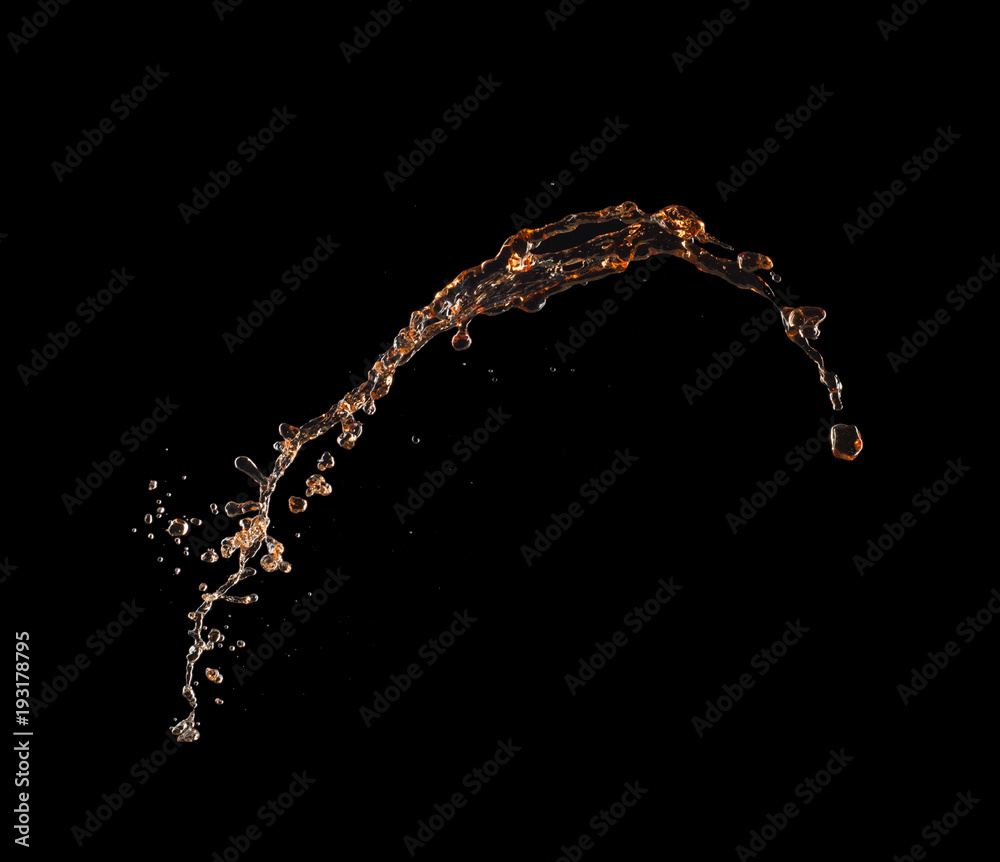 Isolated shot of whiskey splash isolated on black background Isolated shot of whiskey splash isolated on black background