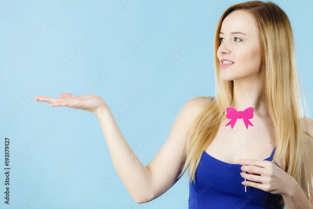 Woman holding carnival accessoies on stick Woman holding carnival accessoies on stick