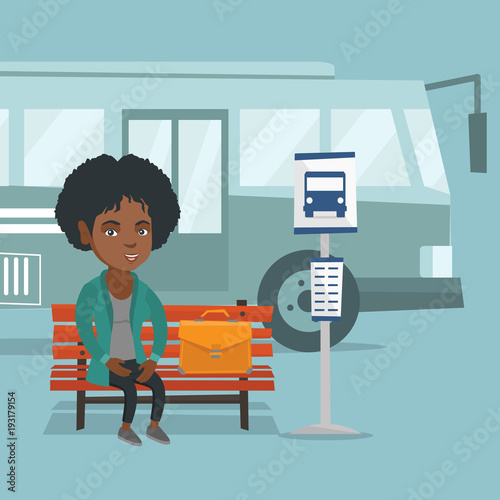 African-american business woman with a briefcase waiting for a bus at the bus stop. Young smiling business woman sitting on the bus stop bench. Vector cartoon illustration. Square layout.