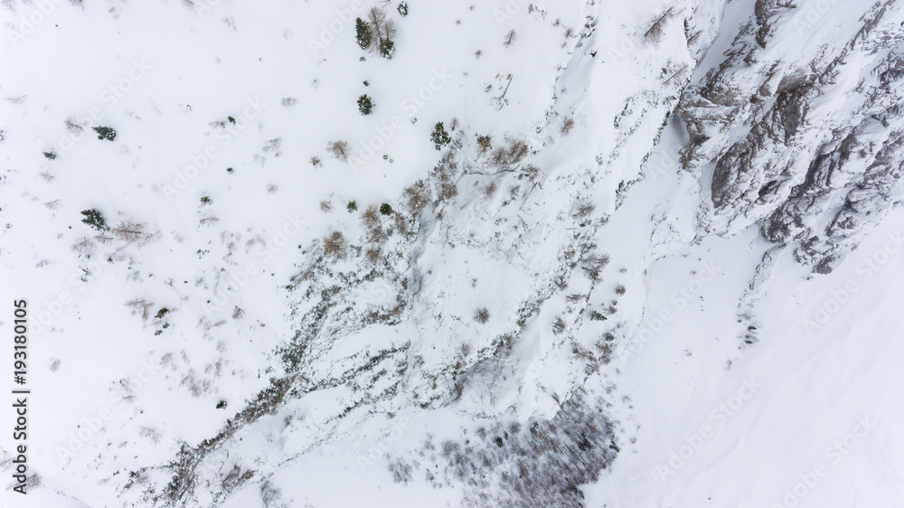 Drop down view of snow covered mountain slopes. Drop down view of snow covered mountain slopes.
