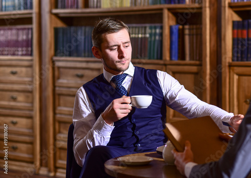 Photography Men in suit sit in library or retro interior, defocused.