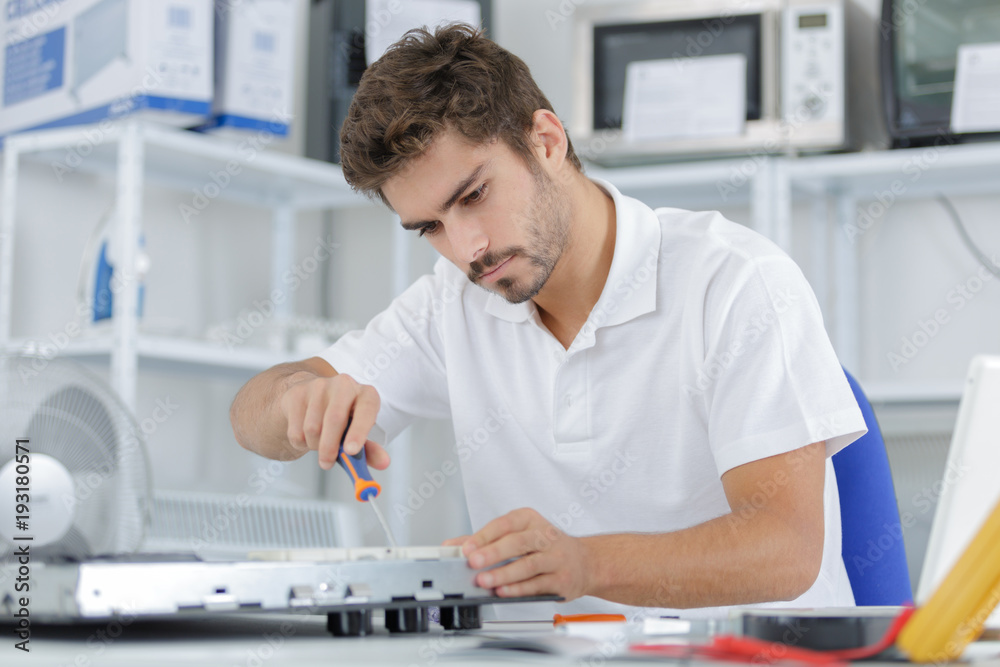 man installing induction hobs in a kitchen man installing induction hobs in a kitchen