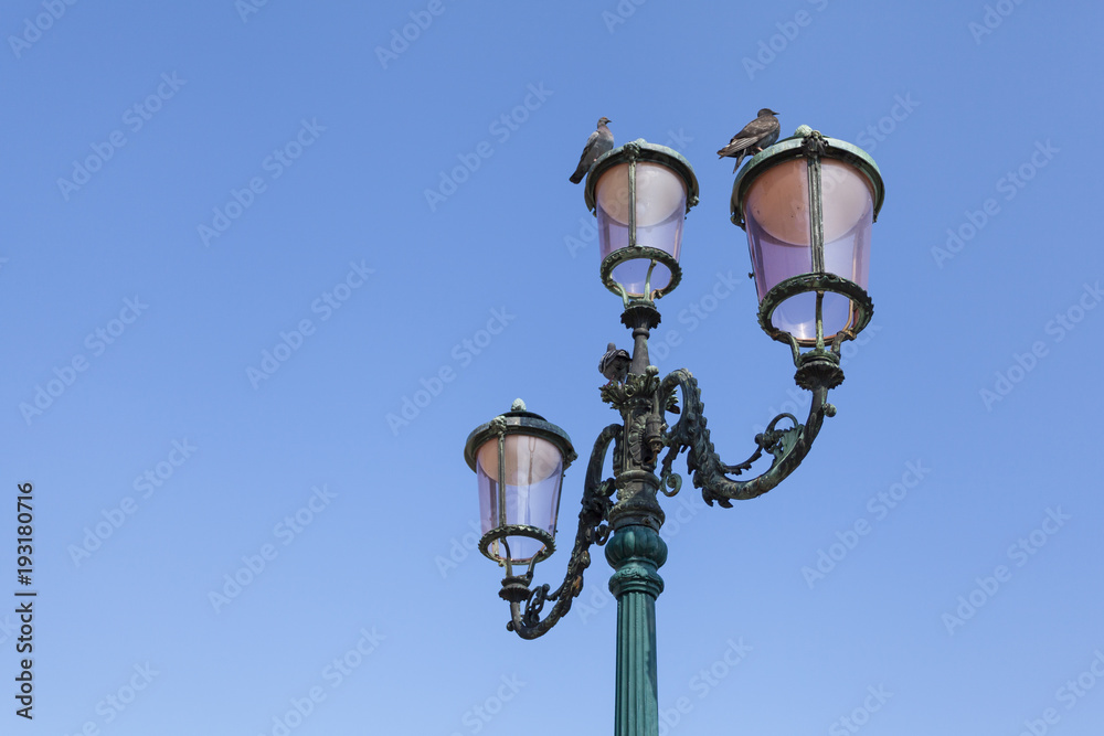 Vintage street lamp against a clear sky. Venice, Italy