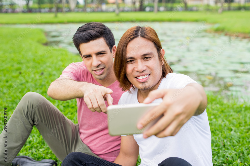 Playful Men Taking Selfie on Smartphone in Park