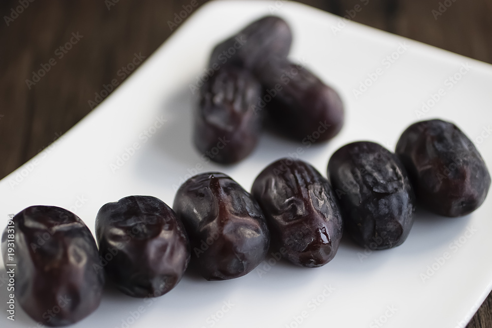 Dried dates on white plate. Dried dates on white plate.