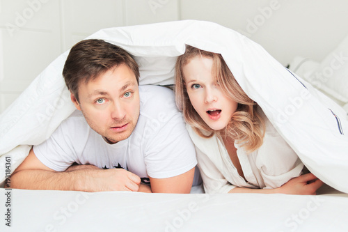 Couple in bed. Amazement
