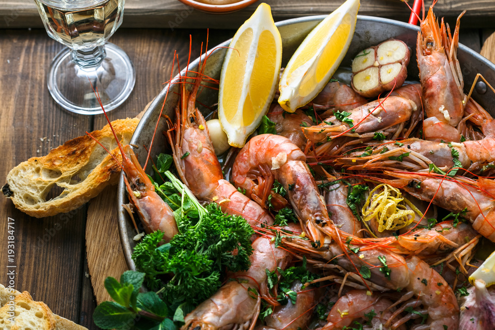 Tasty shrimps with garlic, lemoc, bread and wine
