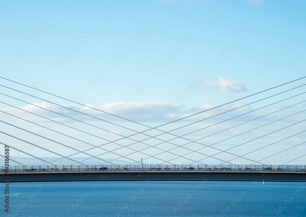 The new Queensferry Crossing Bridge, viewed from the west footpath of the old Forth Road Bridge, showing the cable-stayed construction.. The new Queensferry Crossing Bridge, viewed from the west footpath of the old Forth Road Bridge, showing the cable-stayed construction..