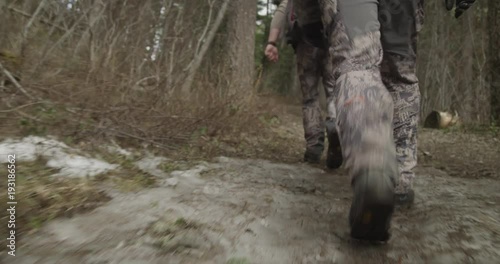 Tracking shot, hunters on forest trailer