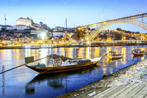 Downtown by Douro river with wine barrels on old boats, Porto, Portugal