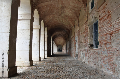 Old archway  destroyed brick wall and stone colonnade in Aranjuez  Spain