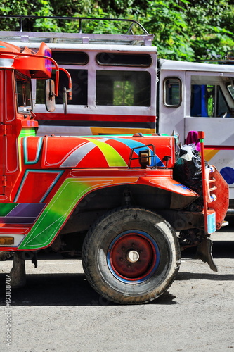 Filipino orange-red dyipni-jeepney parked at the bus station. Sagada-Mountain province-Philippines. 0237