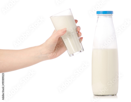 A bottle of milk a glass of milk in hands