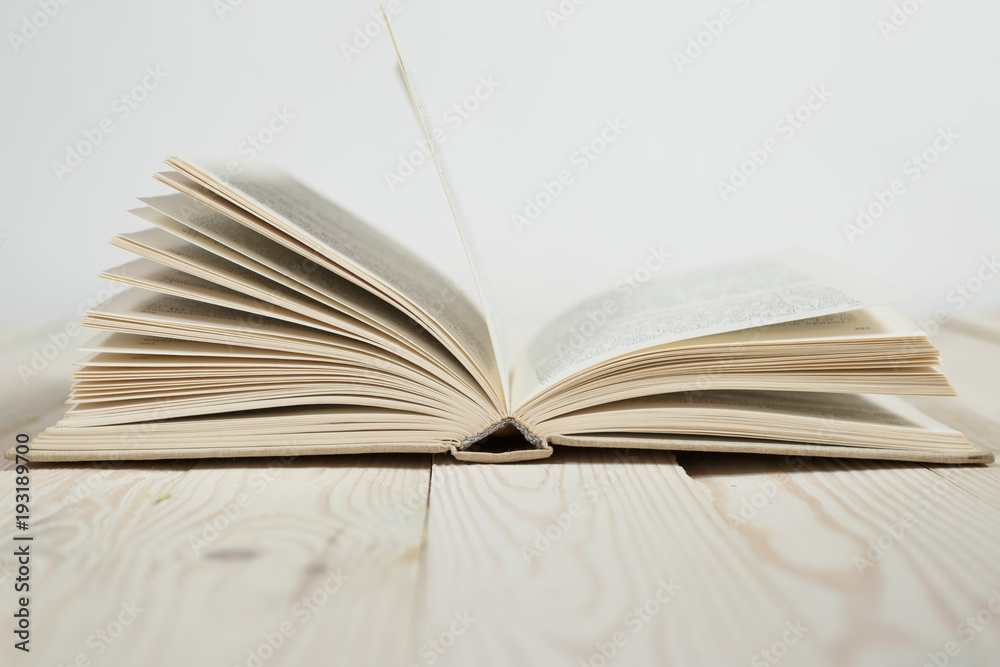 Open of pastel colorsbooks hardback on wooden table. Open of pastel colorsbooks hardback on wooden table.