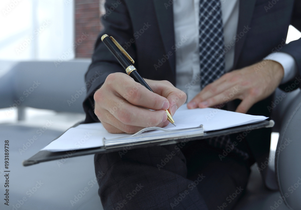 Businessman signs a contract. Holding pen in hand. Businessman signs a contract. Holding pen in hand.