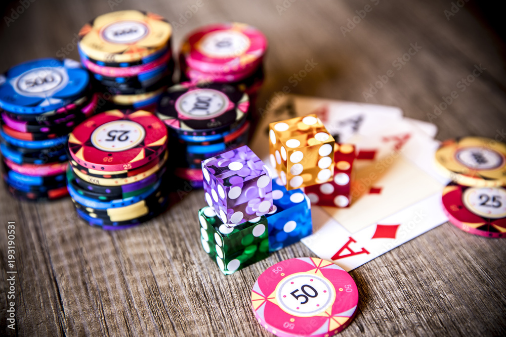 Poker chips, four aces and dice. Selective focus