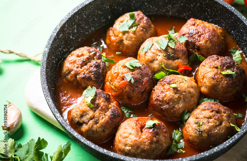 Meat balls in tomato sauce in a frying pan. Meat balls in tomato sauce in a frying pan.