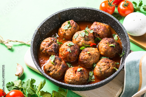 Meat balls in tomato sauce in a frying pan. 