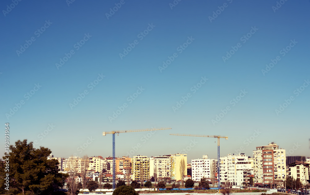 Tirana view modern apartment buildings in construction process clear blue sky, Albania