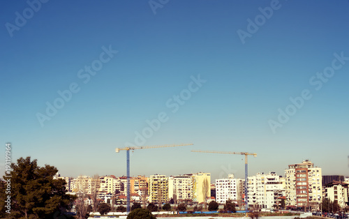 Tirana view modern apartment buildings in construction process clear blue sky, Albania