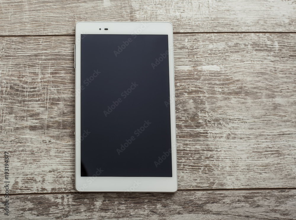 Tablet pc, mobile phone on a woob background Tablet pc, mobile phone on a woob background