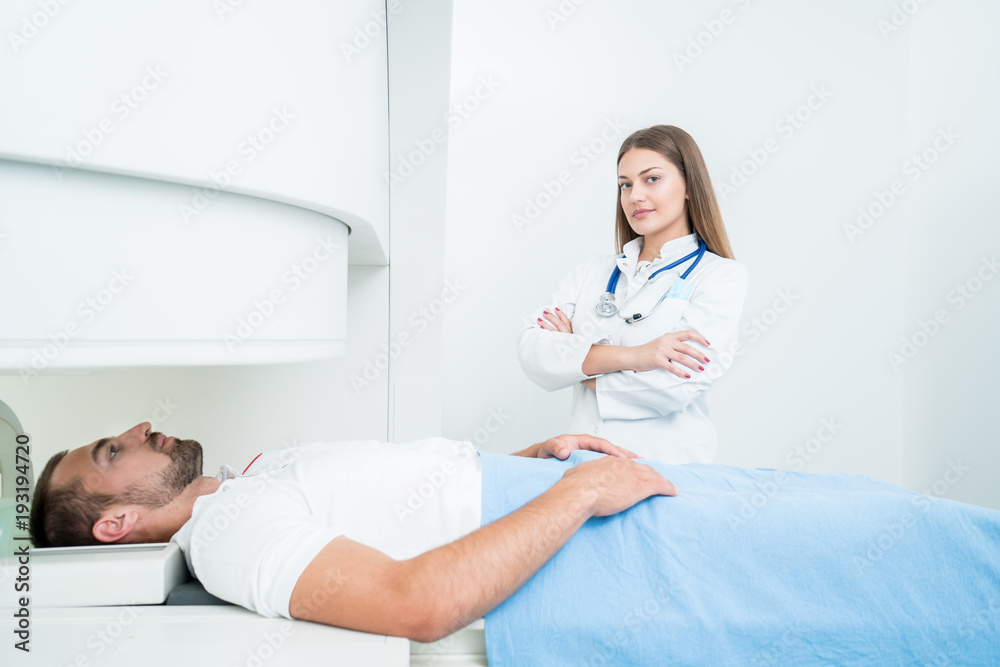 Beautiful female doctor visiting male patient who is in bed. Beautiful female doctor visiting male patient who is in bed.