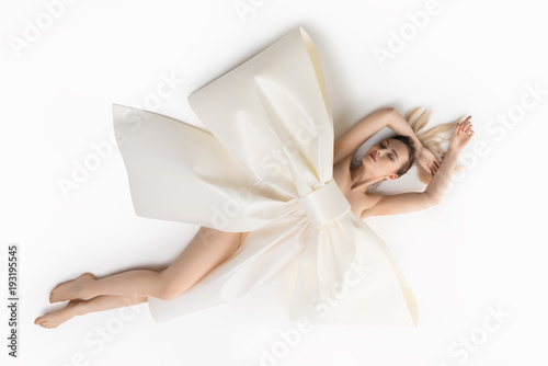Nude girl on the floor with huge decorative bow