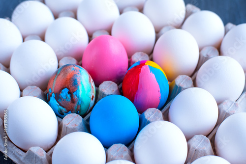 Multicolored eggs among white eggs