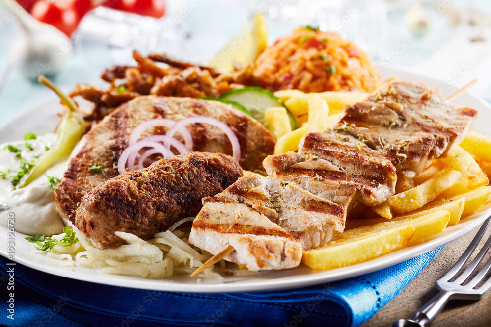 Greek grill plate with gyros, souvlaki and skewers