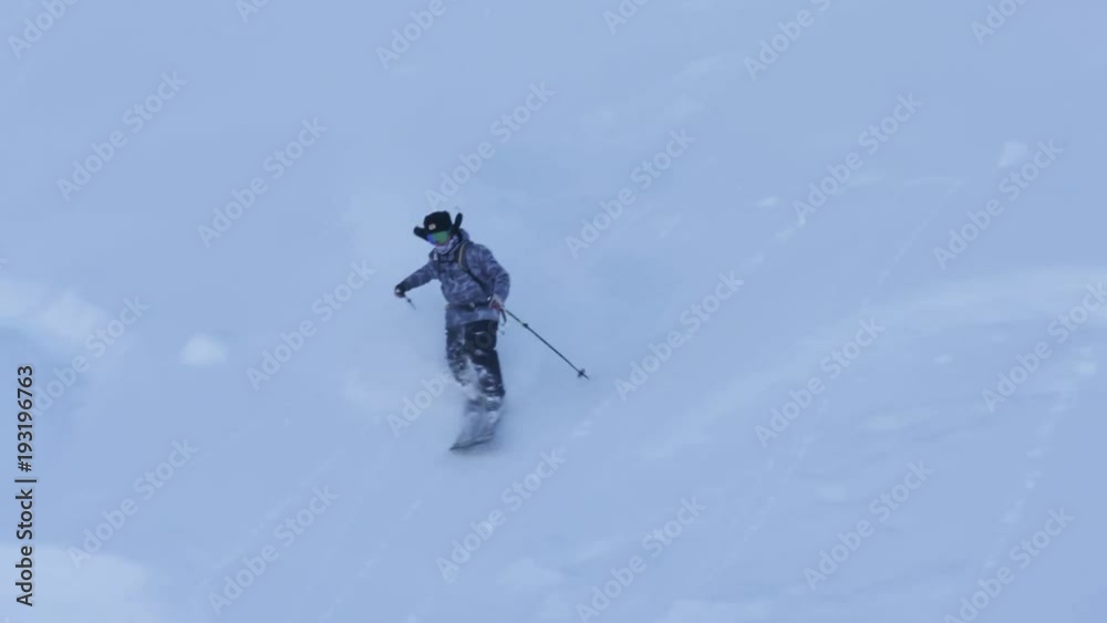 Skier on British Columbia hillside, slow motion