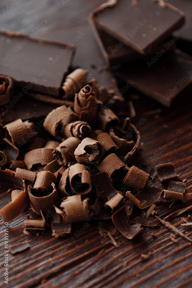 Delicious dark chocolate on a brown background