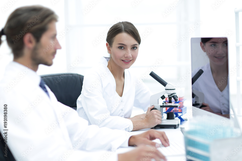Lab expert working on a test using microscope Lab expert working on a test using microscope