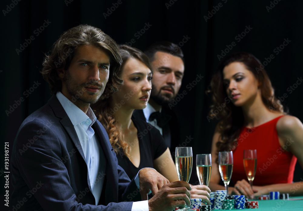 Poker players drink champagne on a black background Poker players drink champagne on a black background