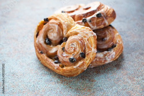 Fresh buns with raisins and icing on old rusty background photo