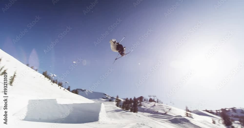 Low angle, skier spins in aerial trick
