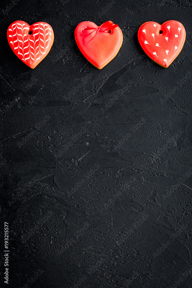St Valentine's Day cookies in shape of heart on black background top view copy space St Valentine's Day cookies in shape of heart on black background top view copy space