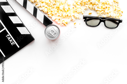 Cinema background. Film watcing. Glasses, drink, popcorn and clapperboard on white background top view copy space photo