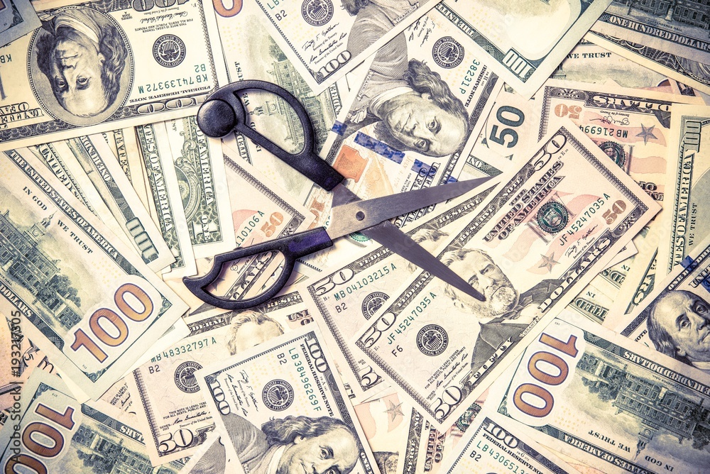 Symbol of the sequester of the budget on the background of the American currency Symbol of the sequester of the budget on the background of the American currency