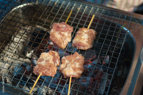 Close up Grilled Pork stick cooking night market, Thai cuisine traditional signature street food, quick and easy eating