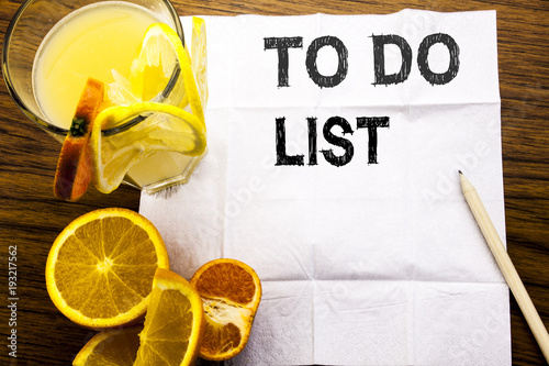 Conceptual text caption showing To Do List. Concept for Plan Lists Remider written on tissue paper on the wooden background with pen healthy juice and orange fruit in the restaurant photo