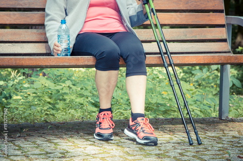Vintage photo, Senior woman resting after nordic walking, sporty lifestyles in old age concept