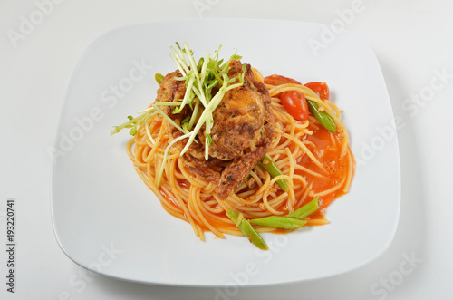 Spaghetti with soft shell crab in white dish. 