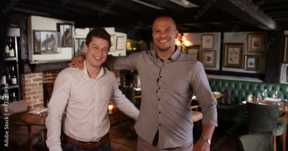 4K Smiling business partners in a new bar hold up a sign to show they are open 4K Smiling business partners in a new bar hold up a sign to show they are open