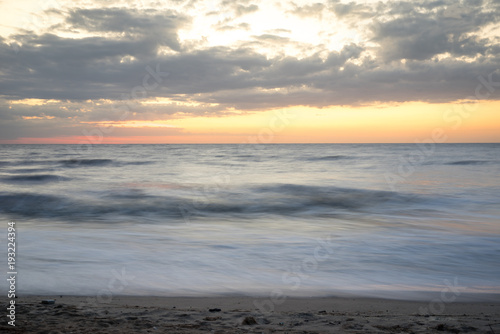 Horizontal line of the sea at sunrise  long exposure   dramatic wave
