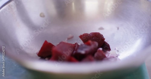 4K Unrecognizable skilled chef preparing gourmet starter dish with fresh beetroot. Could be restaurant, hotel or domestic kitchen. photo