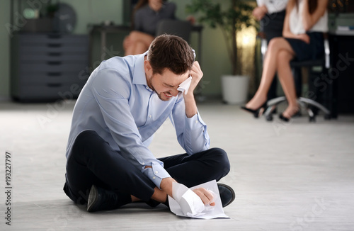 Young man being bullied at work © Africa Studio