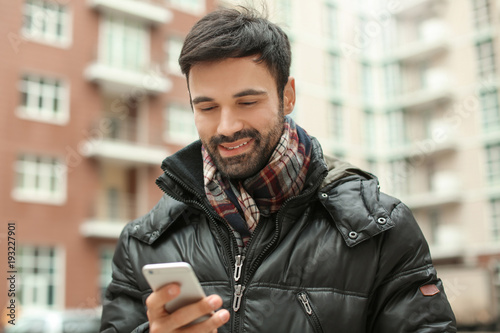 Young man using mobile phon...