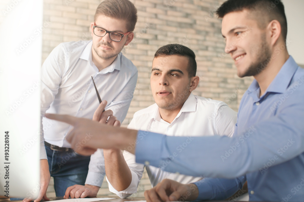 Fototapeta premium Young men working in office