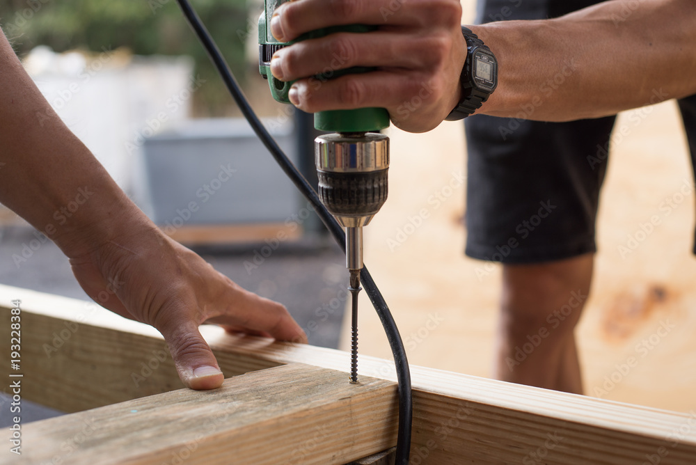 man worker working with an electric drill