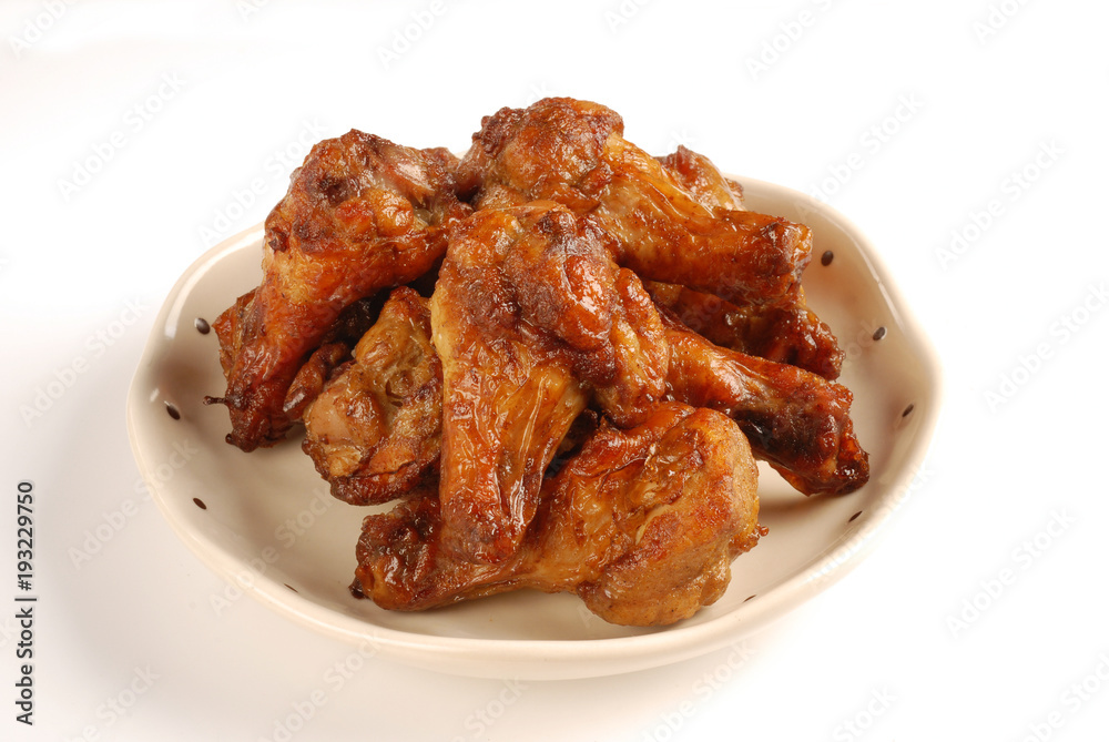 Grilled chicken legs with cumin on white background Grilled chicken legs with cumin on white background